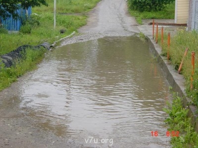 Это лужа. Справа наш забор. Столбик гнутый, машина въехала, 2 раза одна и та же.